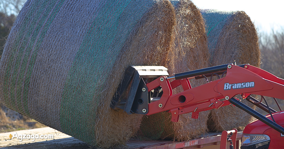 bale spears mounted on frame lifting bale